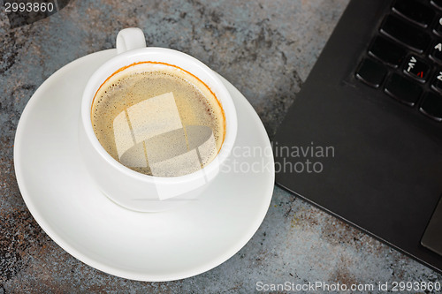 Image of Shot of cup of coffee and kayboard