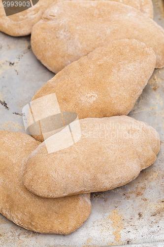 Image of Loaves of homemade pita bread vertical