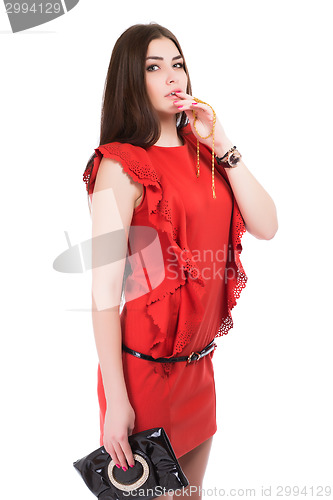 Image of Portrait of brunette posing in red dress