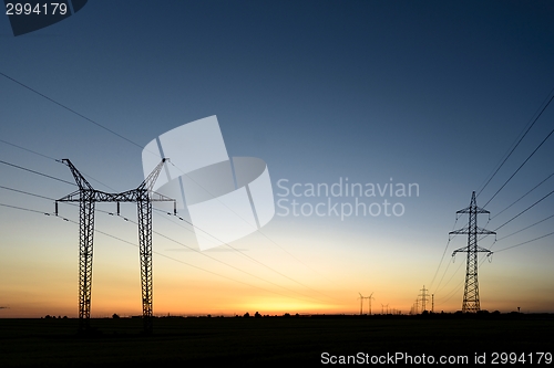 Image of Large transmission towers at sunset