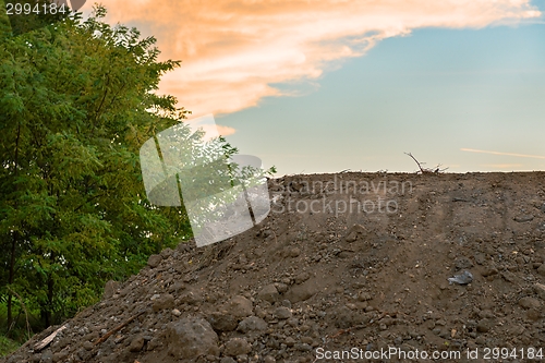 Image of Large pile of soil under blue sky