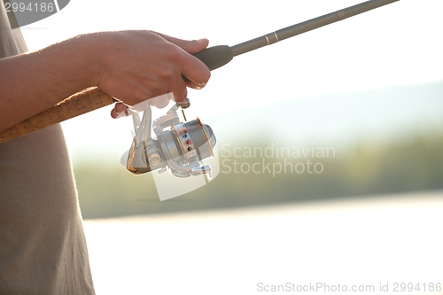 Image of Modern clean fishing rod in hands