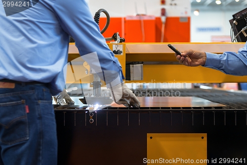 Image of Machine cutting steel in a factory