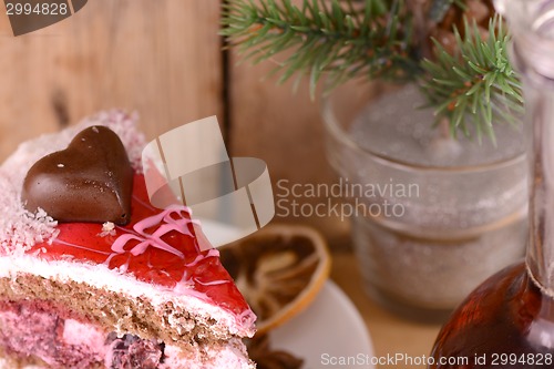 Image of pieces of cake on wooden background with flowers and carafe
