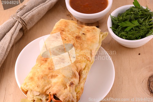 Image of Burrito - traditional Mexican food, on a white plate