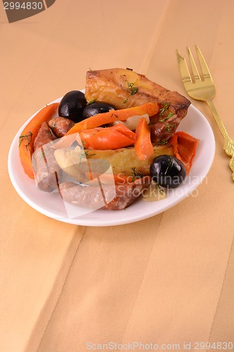 Image of Grilled sausage with fresh salad on wooden background