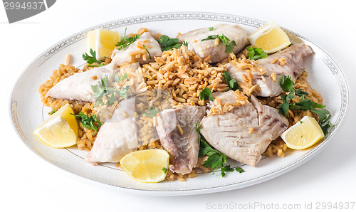 Image of Lebanese fish rice and nuts serving dish