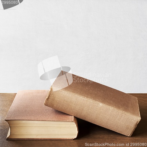 Image of two brown books on the table