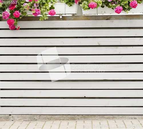 Image of gray horizontal plank fence with flowerpots