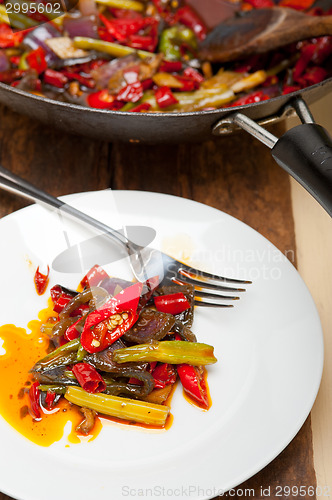 Image of fried chili pepper and vegetable on a wok pan