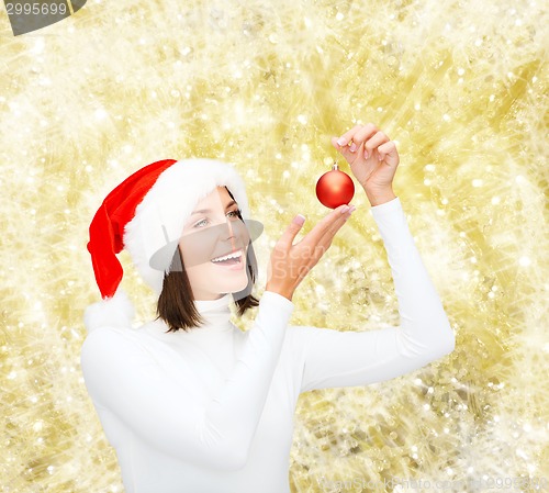 Image of woman in santa helper hat with christmas ball