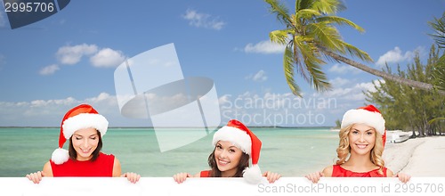 Image of women in santa helper hat with blank white board