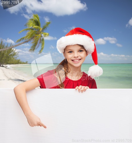 Image of girl in santa helper hat with blank white board