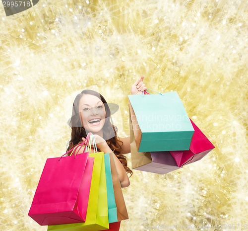 Image of smiling woman with colorful shopping bags