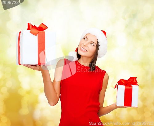 Image of smiling woman in red dress with gift box