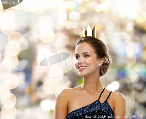 Image of smiling woman in evening dress wearing crown