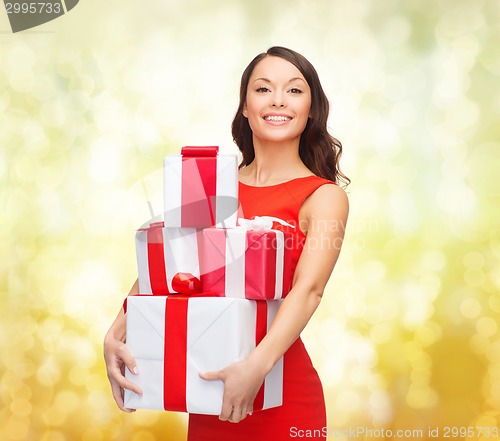 Image of smiling woman in red dress with gift box