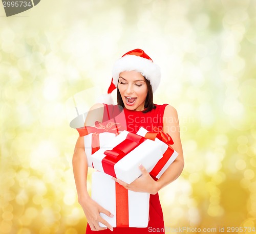 Image of smiling woman in red dress with gift box