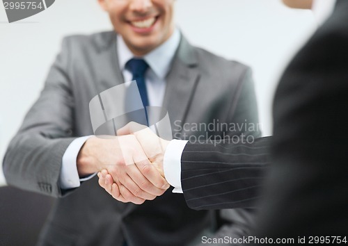 Image of two businessmen shaking hands in office