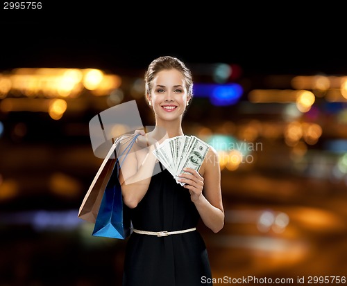 Image of smiling woman in dress with shopping bags