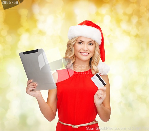 Image of woman in santa hat with tablet pc and credit card