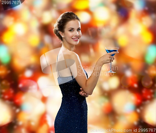 Image of smiling woman holding cocktail