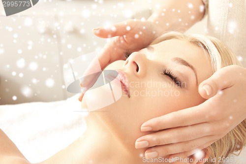 Image of beautiful woman getting face or head massage