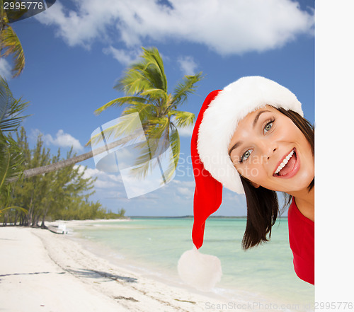 Image of woman in santa helper hat with blank white board