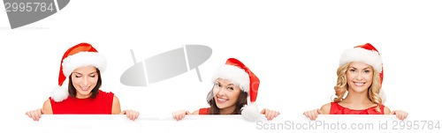 Image of women in santa helper hat with blank white board