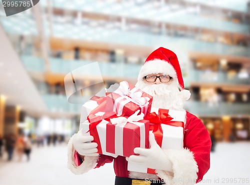 Image of man in costume of santa claus with gift boxes