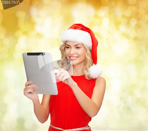 Image of woman in santa helper hat with tablet pc