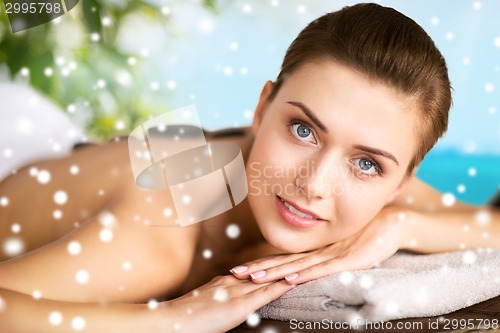 Image of woman in spa salon with hot stones