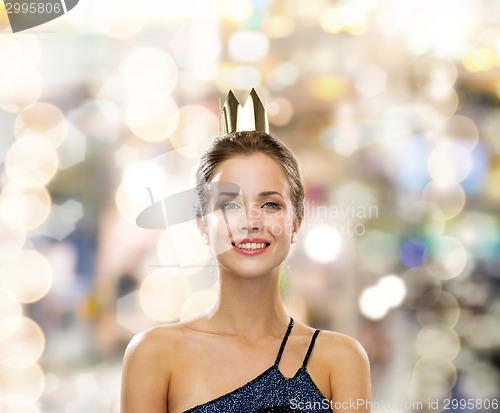 Image of smiling woman in evening dress wearing crown