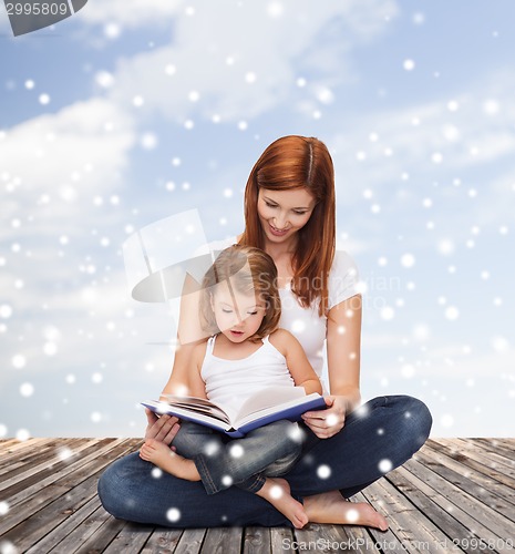 Image of happy mother with little girl and book
