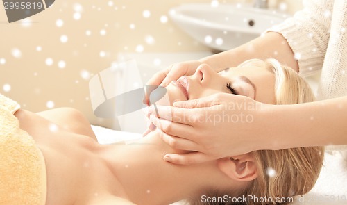 Image of beautiful woman getting face or head massage