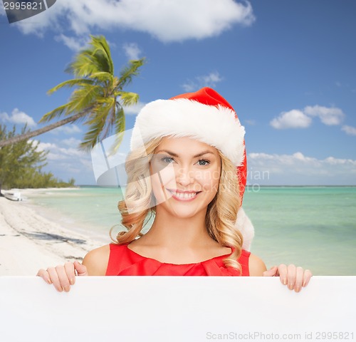 Image of woman in santa helper hat with blank white board