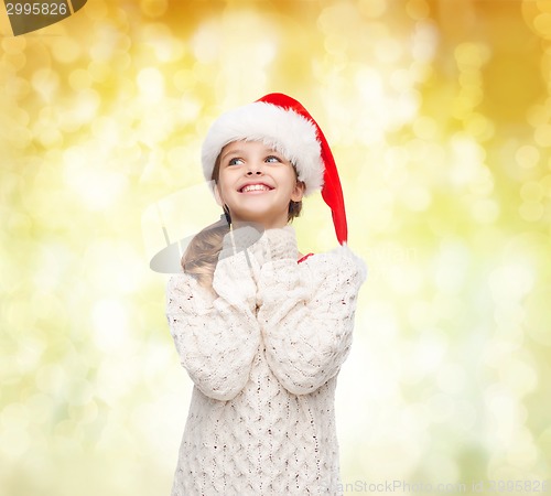 Image of dreaming girl in santa helper hat