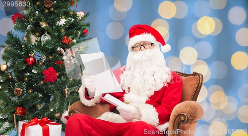 Image of man in costume of santa claus with letter