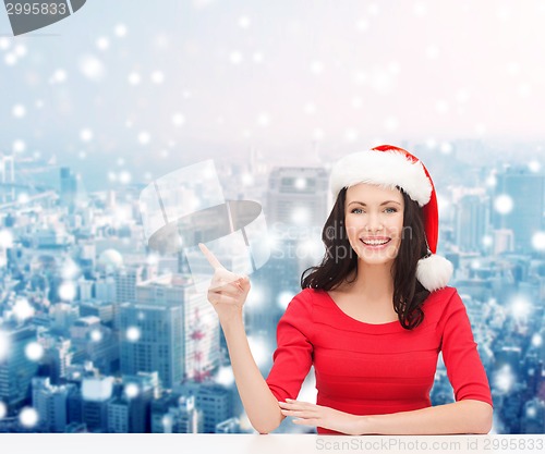 Image of smiling woman in santa helper hat