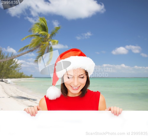 Image of woman in santa helper hat with blank white board