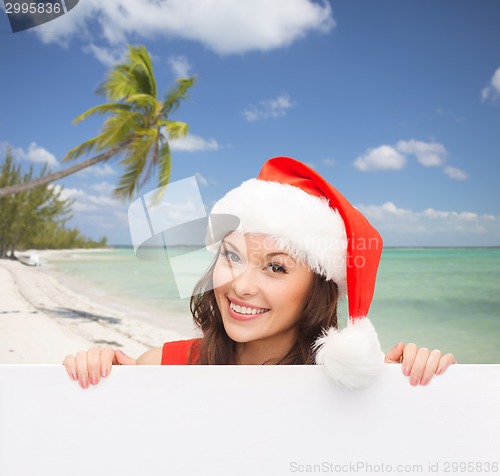 Image of woman in santa helper hat with blank white board