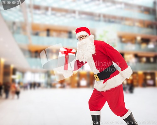 Image of man in costume of santa claus with gift box