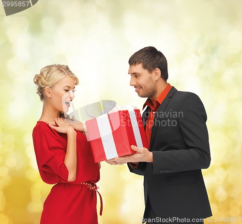 Image of smiling man and woman with present