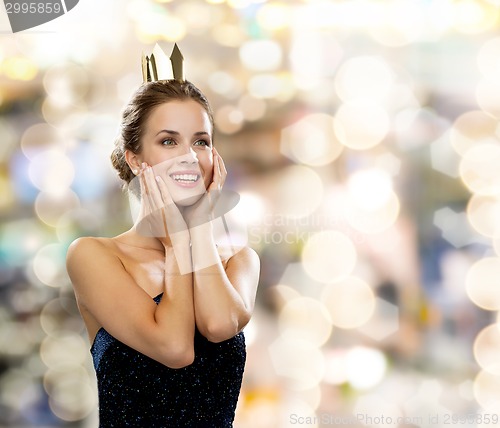 Image of smiling woman in evening dress wearing crown