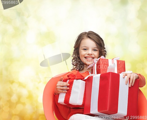 Image of smiling little girl with gift boxes