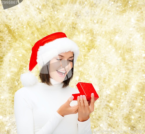 Image of smiling woman in santa helper hat with gift box