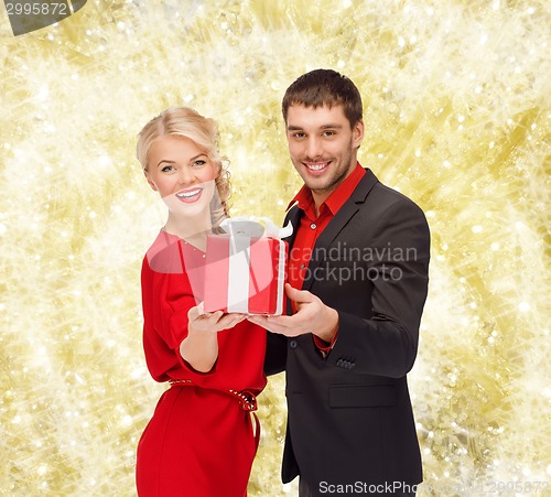 Image of smiling man and woman with present