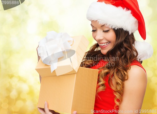 Image of smiling woman in red dress with gift box