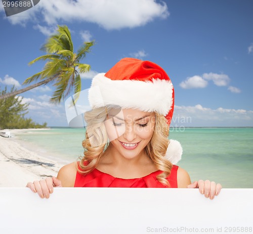 Image of woman in santa helper hat with blank white board