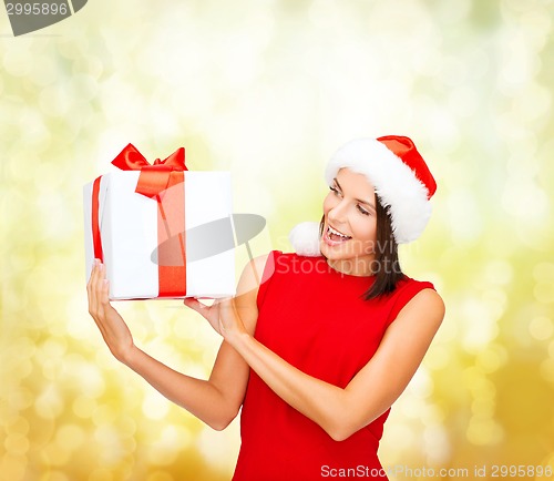 Image of smiling woman in red dress with gift box